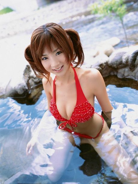 Dreamy cute gravure idol with pig tails in a red skimpy bikini