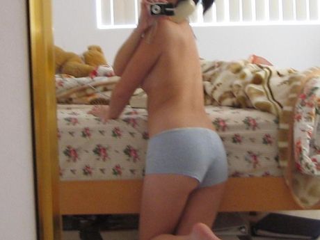 Thai girl taking her own pics while having a phone call