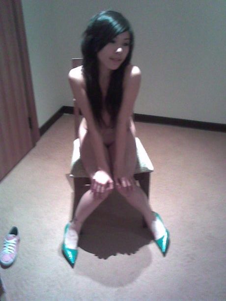 Two Asian girls posing nude in a hotel room