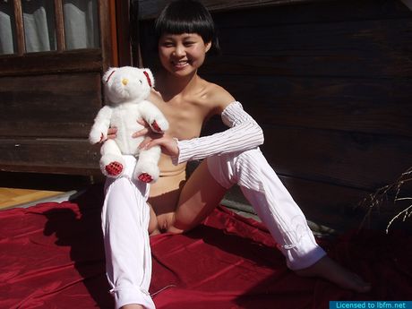 Young Angel strips outdoors and spreads her legs to warm up her yummy bald pussy