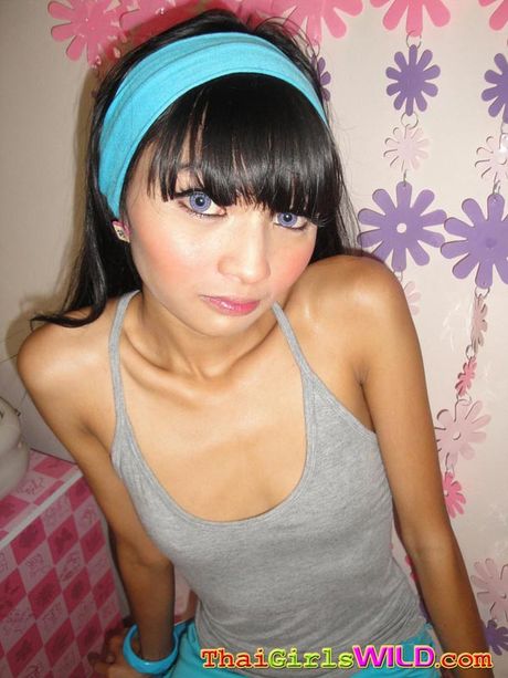 Incredibly skinny Thai teen Eaw strips for us in her bedroom