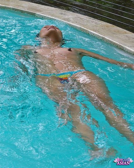 Amateur Asian girl with tiny tits strips and displays her hairy cunt