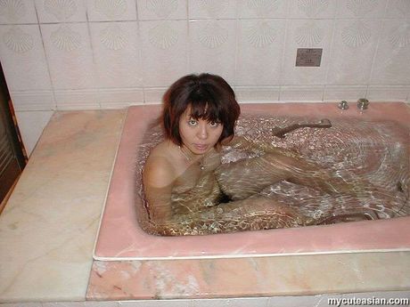 Asian teen with a tiny ass strips and toys her hairy pussy with a dildo