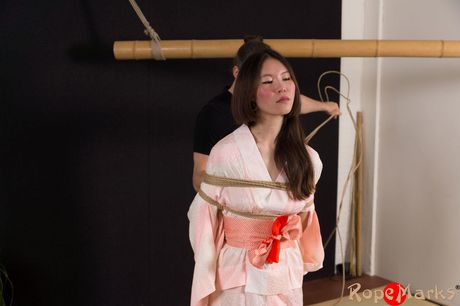 Asian amateur teen strips off and bares her tiny tits and pussy