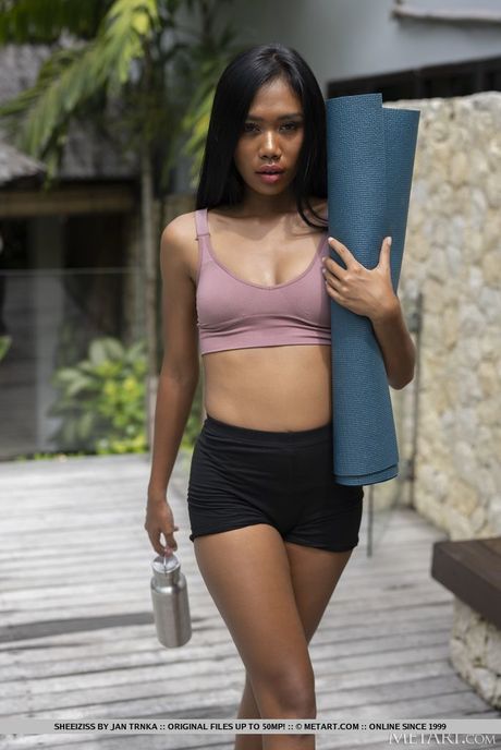 Asian babe Sheeiziss strips and shows her tattooed body in the pool